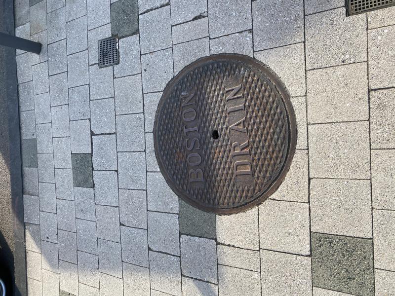 Image of a grate that says "Boston Drain"