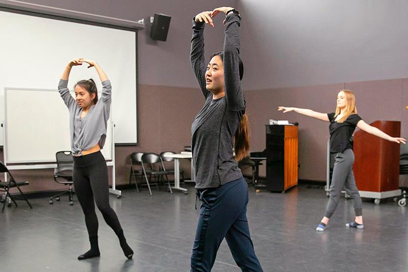3 students rehearse ballet in a studio