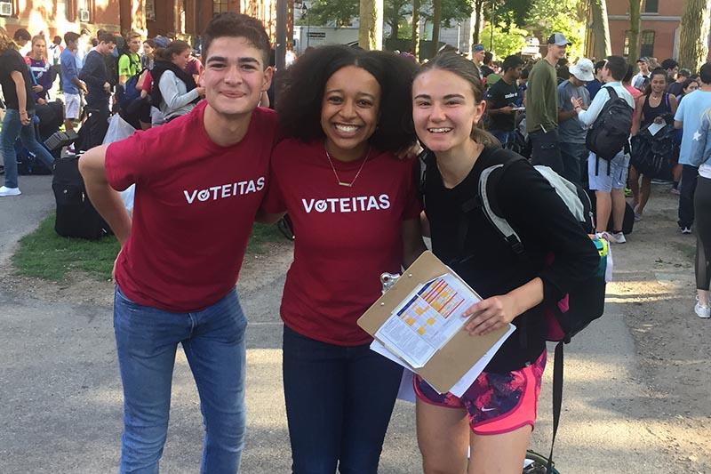 3 first-year stduents in harvard yard on move-in day