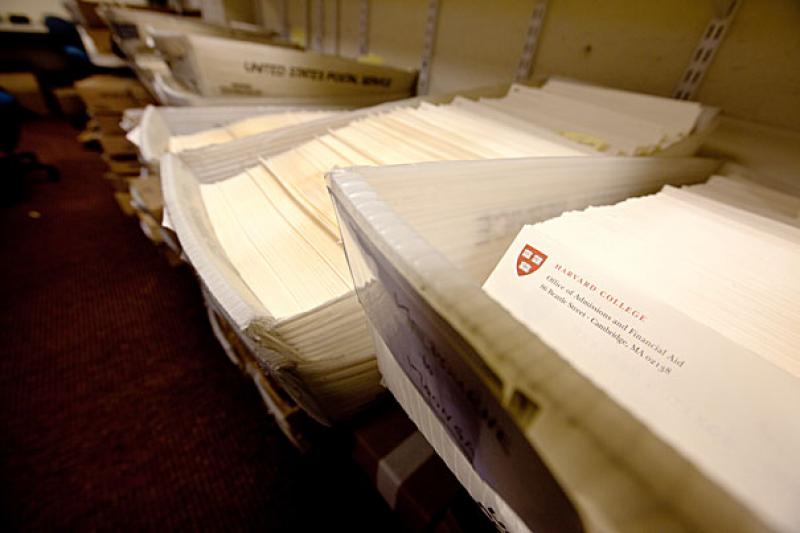 Dozens of admissions packets in mailing bins