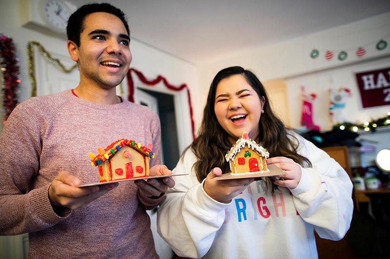 Lena Lofgren '23 and Kyle Felter '23 show off their completed gingerbread houses