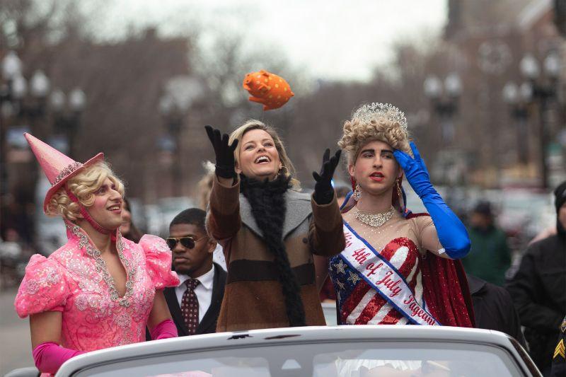 Hasty Pudding's Woman of the Year Elizabeth Banks catches a stuffed pig during the parade with Eli Russell '20 (left) and Scott Kall '20.