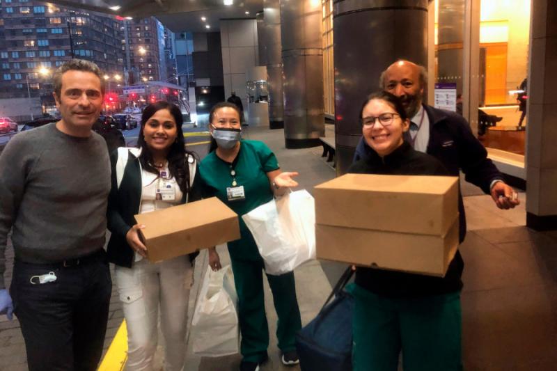 Luca Di Pietro (left) makes the first meal delivery from Feed the Frontlines NYC to the NYU Langone Medical Center's Emergency Department.