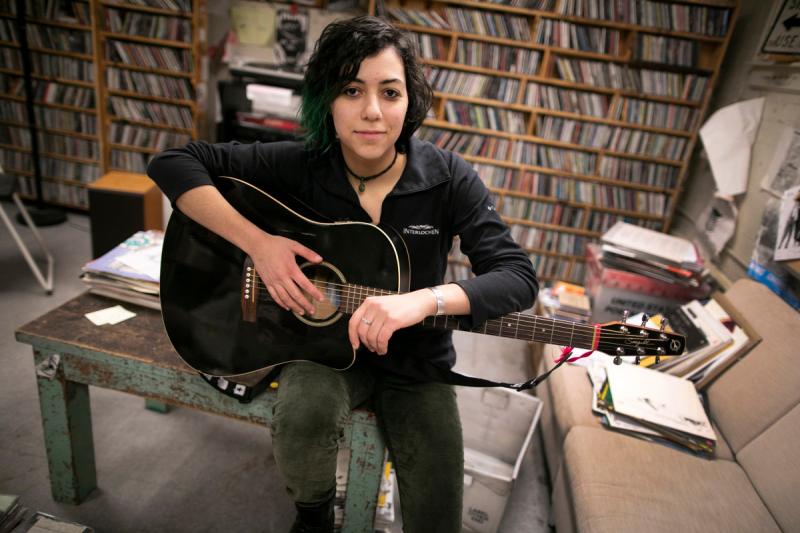 Emily Spector '21 is pictured with her guitar at WHRB, the radio station at Harvard, where Spector is the general manager.
