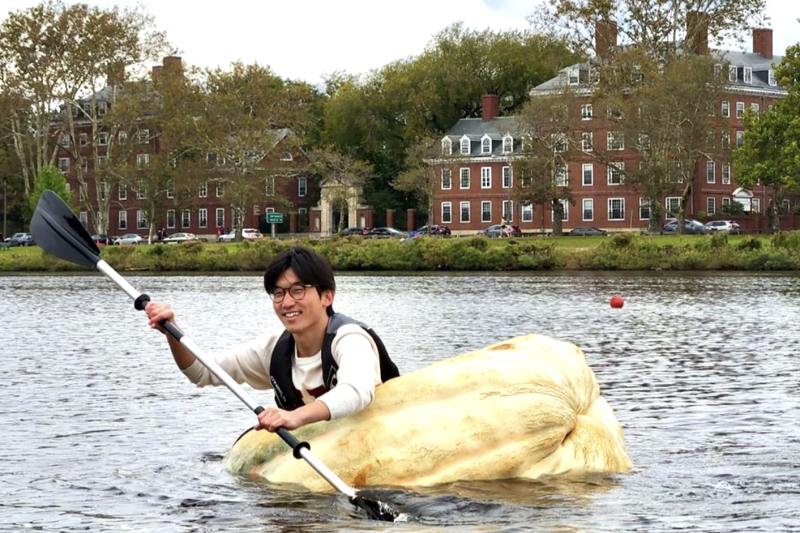 Benjamin Chang rows a hollowed-out 1,500-pound pumpkin across the Charles River.
