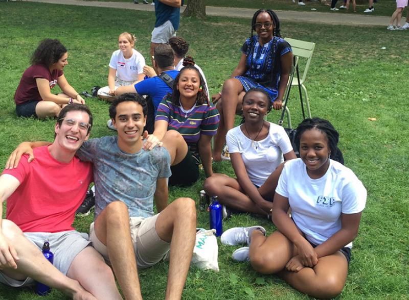 students sitting in Harvard Yard