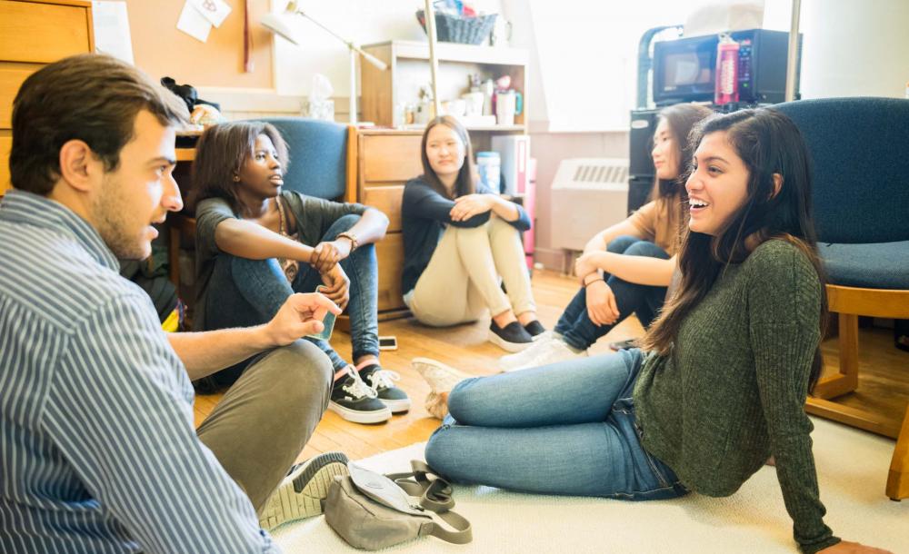 students in their dorm sitting around talking