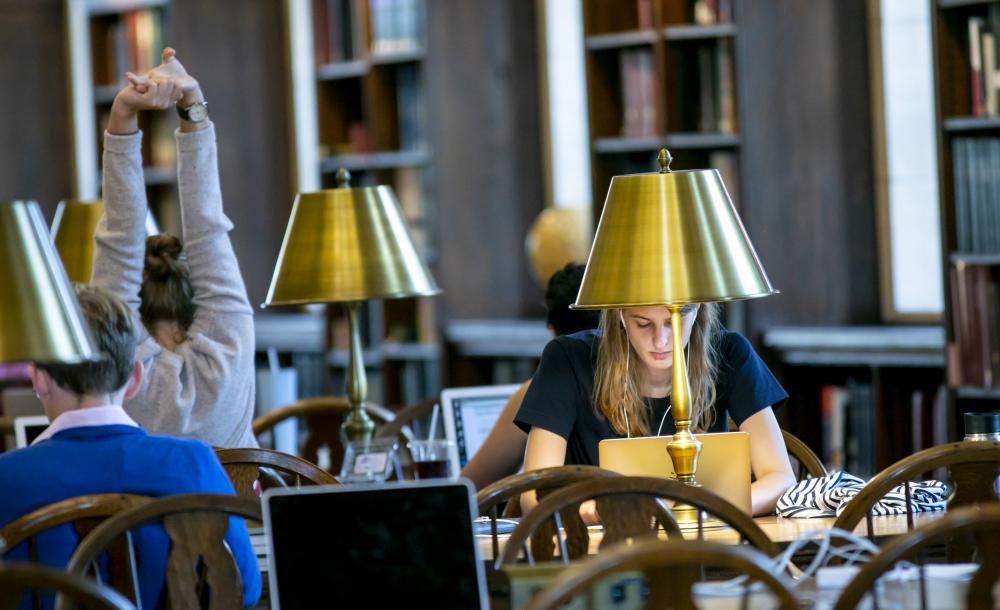 students sitting at a table studying in the library
