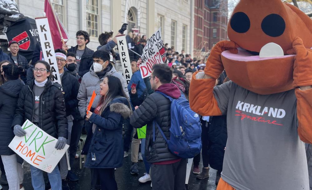 Students gather around the John Harvard statue in Harvard Yard in housing day festive garb and costumes for the traditional Housing Day festivities.