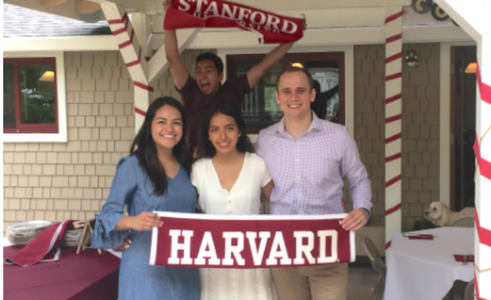 Students holding Harvard flag