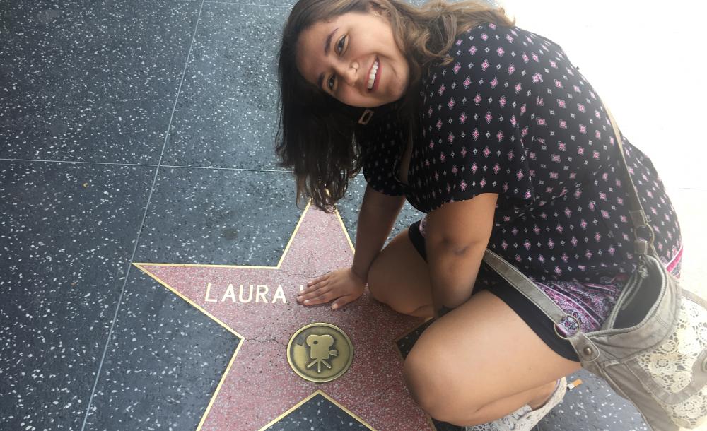 student sitting on the Hollywood Walk of Fame
