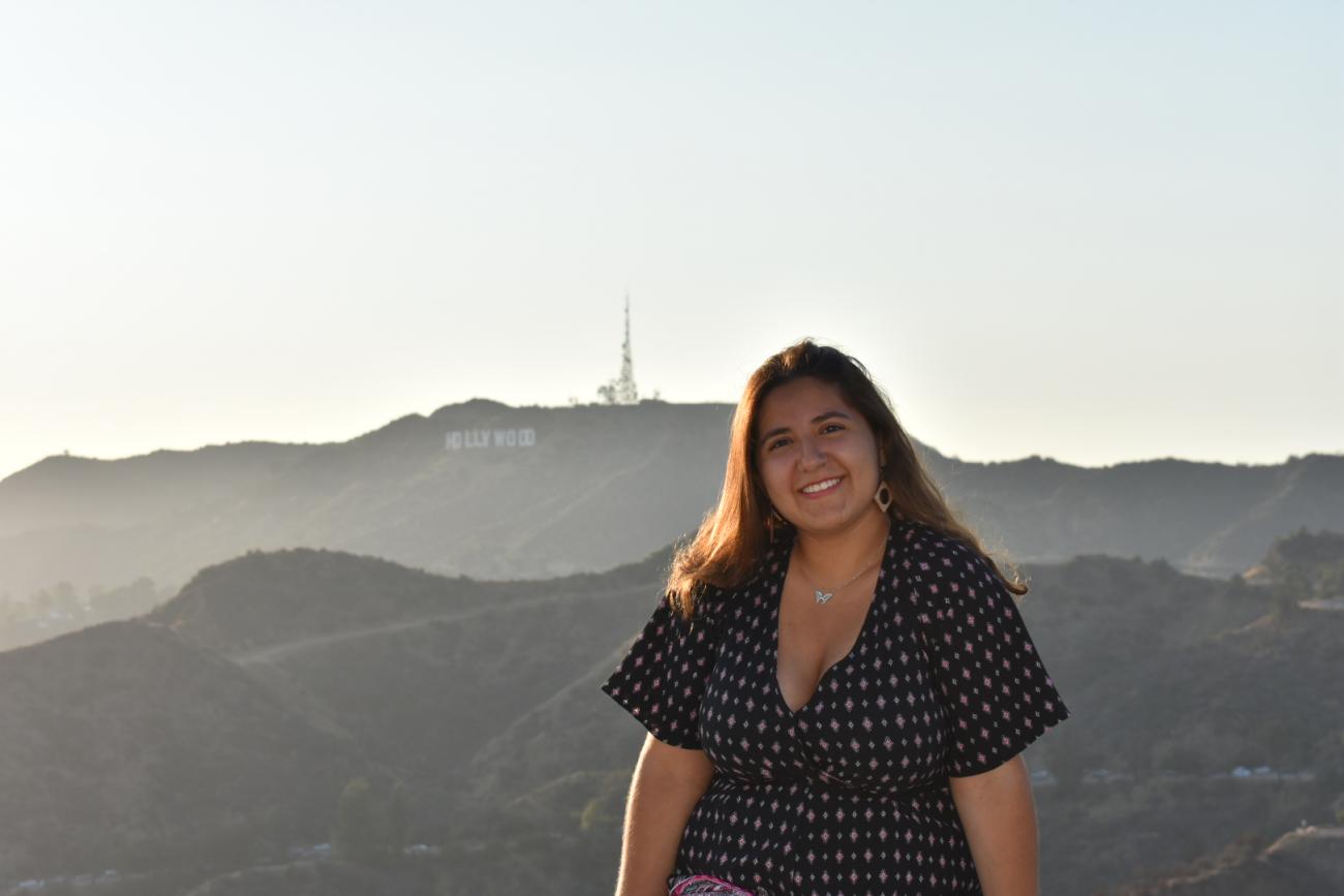 a student in front of Hollywood sign