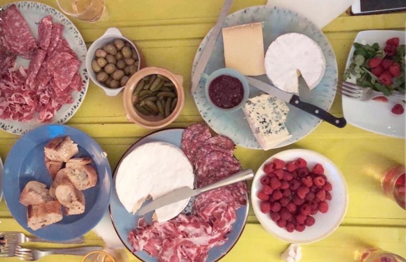 Picnic dinner, with cheese, charcuterie, berries, and bread