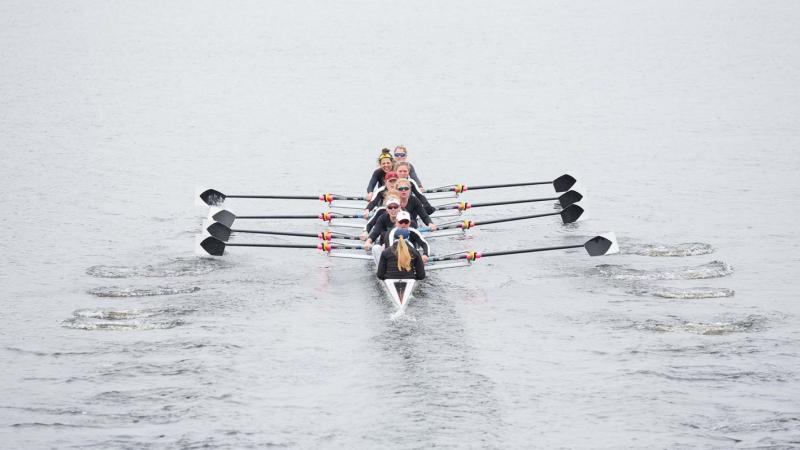 Image of boat and women rowing on a body of water