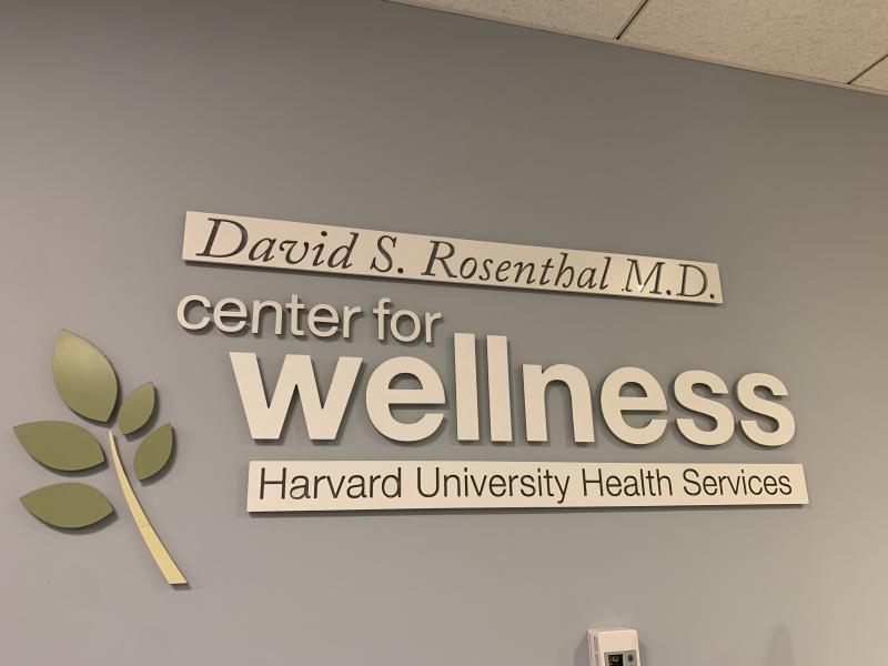 A sign stating "center for wellness" at the Harvard University Health Services
