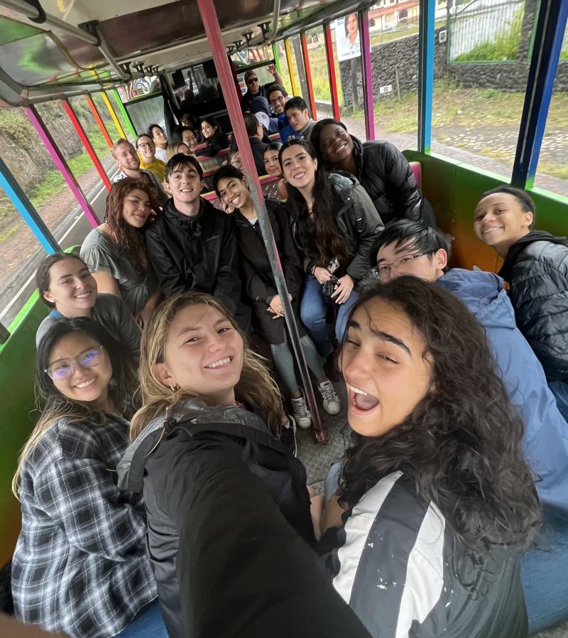 A group of students posing for a photograph in a bus