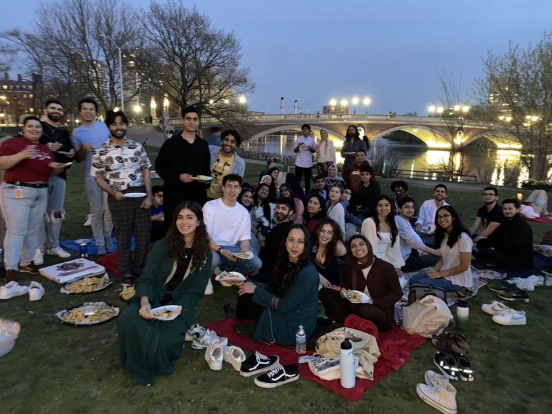 Students eating Iftar by the Charles River