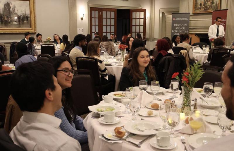 Some students and faculty members sitting at a table during the student-faculty dinner in the Harvard Faculty Club. 