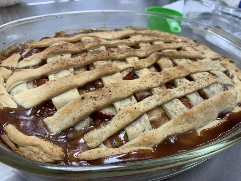 Image of an apple pie with a cross-hatched dough strip design on top.