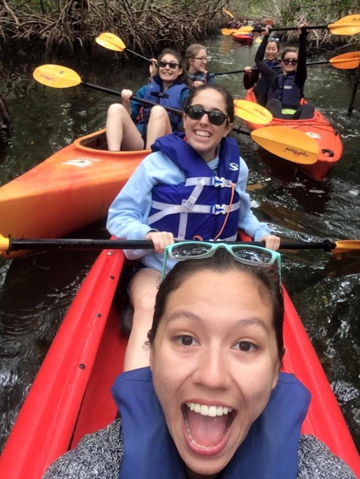 Author kayaking with her a cappella group