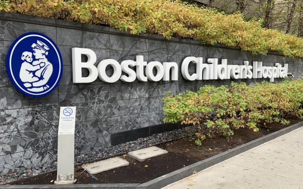 Picture of a Boston Children's Hospital sign placed across a stone wall.