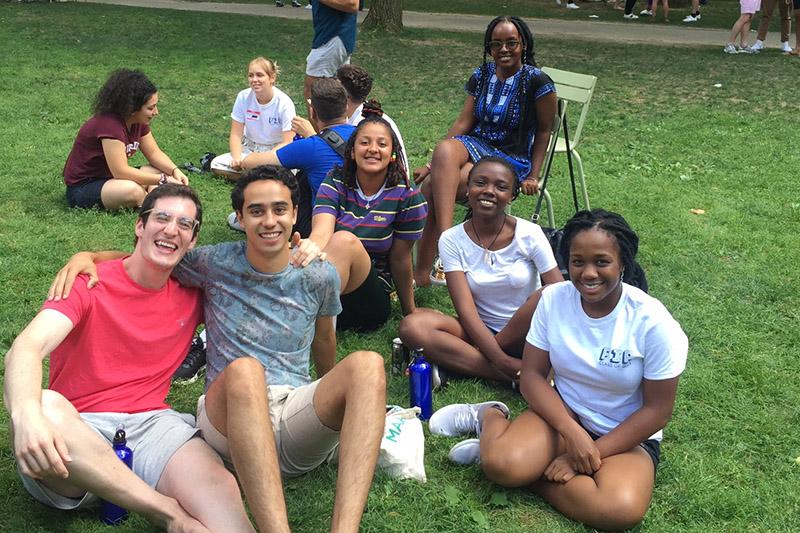 students sitting in Harvard Yard