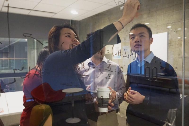 Harvard College Data Analytics Group CEO Jerry Huang, pictured in pre-pandemic days with Karen Chan, decided his group would help others, including the World Health Organization, by providing "data-driven insights related to COVID-19."