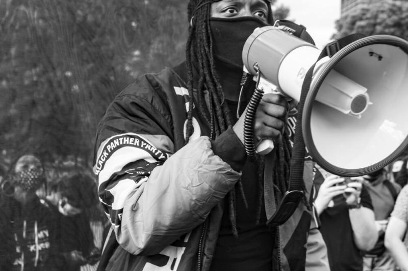 A protester in Boston was photographed by OJ Slaughter. Slaughter was one of 12 artists awarded one-time honorariums by the Harvard University Committee on the Arts.