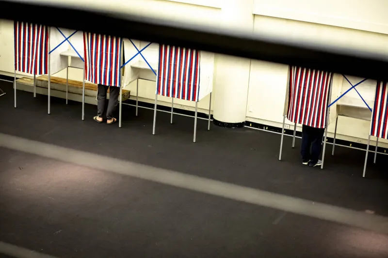 Individuals voting at the polls.