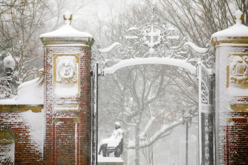 Harvard Yard's Johnston Gate is pictured during a December snowstorm.