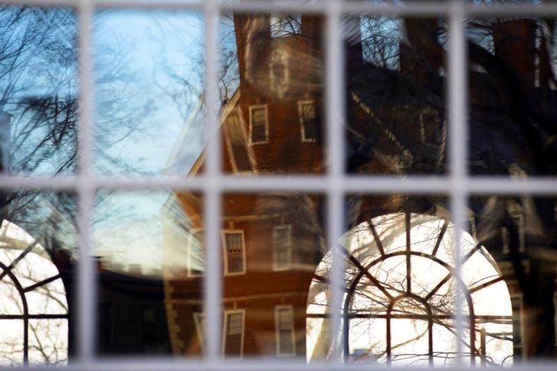 Kirkland House is reflected in the windows of Winthrop House.