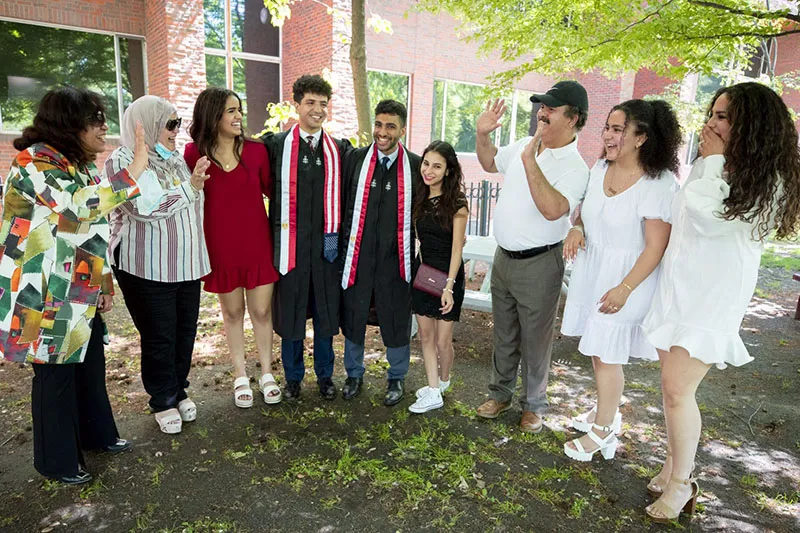 The families of Harvard friends Abdelaziz “Zizo” Nasr Bahnasy ’21 (center, left) of Currier House and Hassam Nasr Mabed ’21 (center, right) of Winthrop House meet on campus.