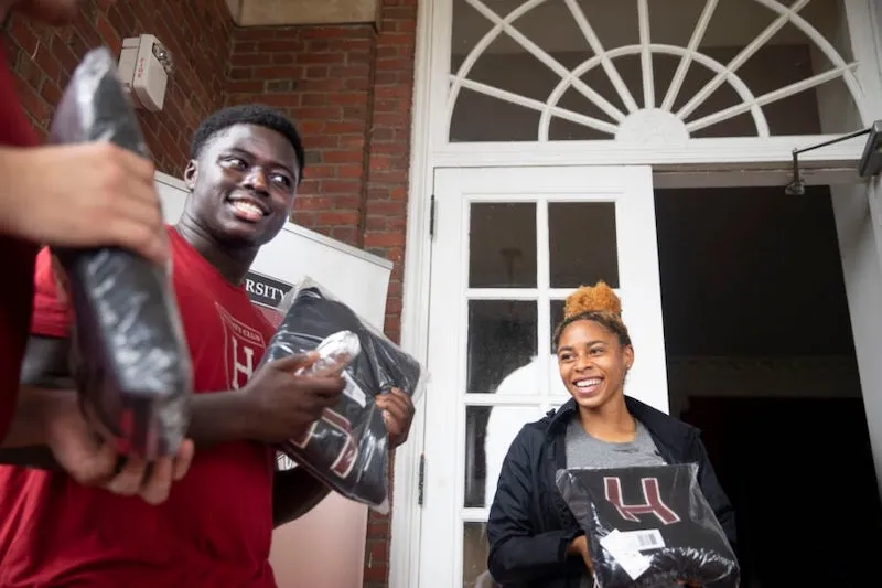 Football player Kwaku Adubofour ’24 and DaLoria Boone ’22 of women's track and field receive their "Major H" varsity letter sweaters at the first distribution day since 2019.