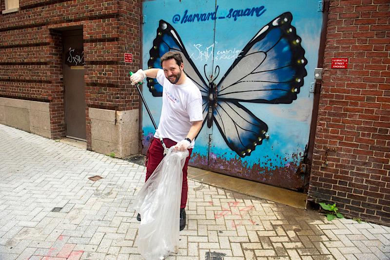 Team leader Kody Christiansen '23 cleans up Palmer Street behind the Coop in Harvard Square.