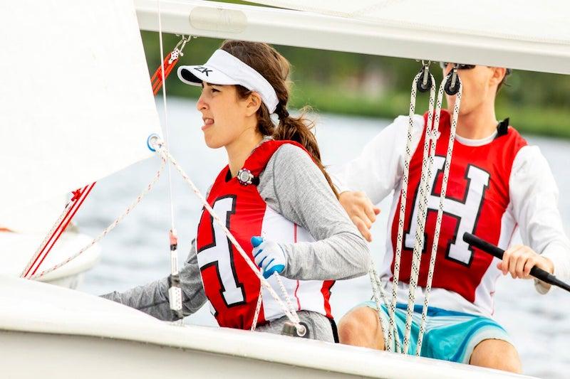 Harvard sailing team members Katie Barkin and Paul Kuechler, both ’22, navigate a drill on the Charles.