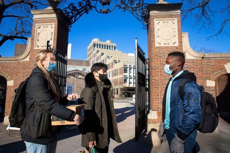Beneath the Science Center gate, first-years Cara Salsberry (from left), Christian Um, and Ejike Ike chat. Beneath the Science Center gate, first-years Cara Salsberry (from left), Christian Um, and Ejike Ike chat.