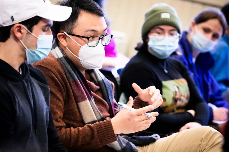 Student Charles Hua (second from left) asks a question in class.
