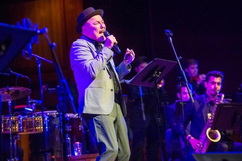 Harvard Arts Medal recipient Rubén Blades, LL.M ’85, sings with the Harvard Jazz Band at Sanders Theatre.