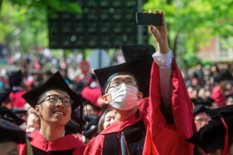 group of seniors in cap and gowns in Harvard yard