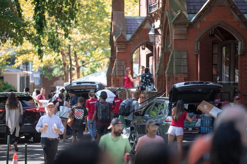 Move-in teams, family, and friends help first-year students make their way into a bustling Harvard Yard.
