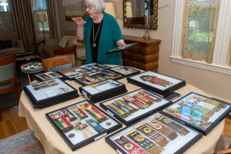 Theda Skocpol displays her collection of badges from early U.S. fraternal groups.