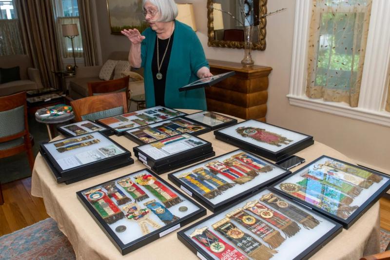 Theda Skocpol displays her collection of badges from early U.S. fraternal groups.
