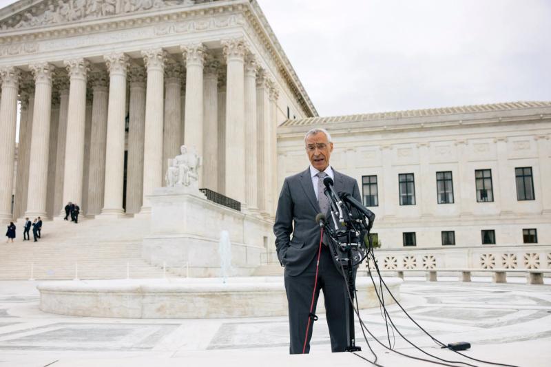 Seth Waxman speaks, standing on Supreme Court steps