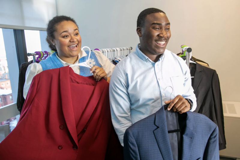 Harvard Undergraduate Association co-presidents LyLena Estabine and Travis Johnson show wide selection of clothes at Crimson Career Closet