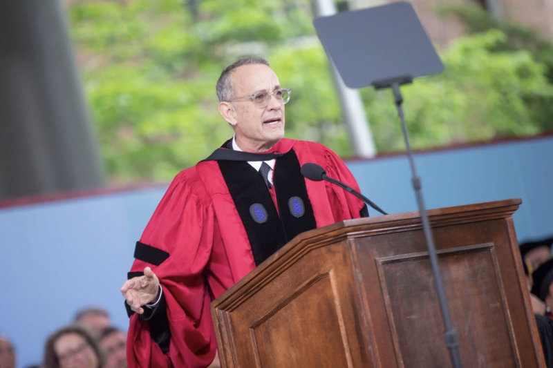 Tom Hanks, wearing regalia at the podium giving his speech on Commencement Day 