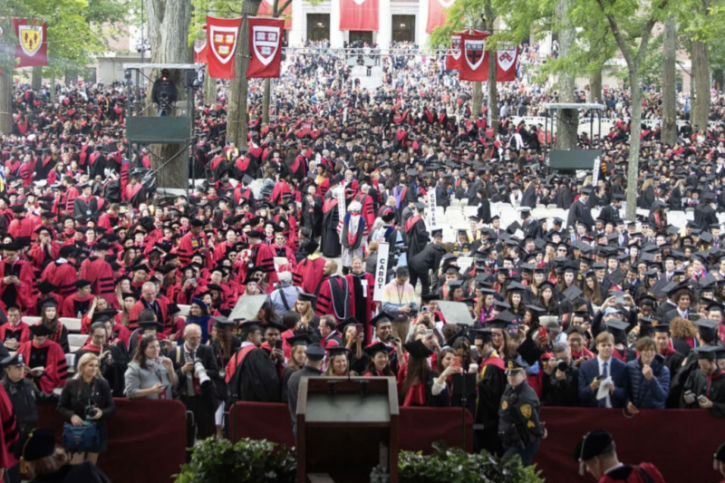 crowd of graduates in Harvard Yard in seats on Commencement