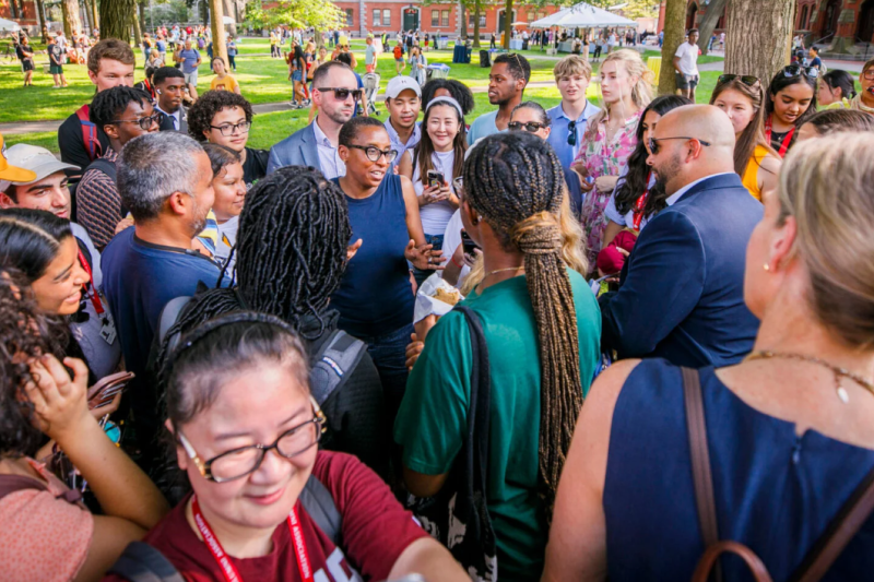 During one of her three stops for ice cream, Harvard President Claudine Gay (center) meets with the community in front of Massachusetts Hall in Harvard Yard.
