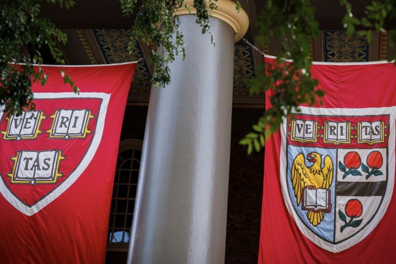 Banners hung on outside of Memorial church with Harvard logo