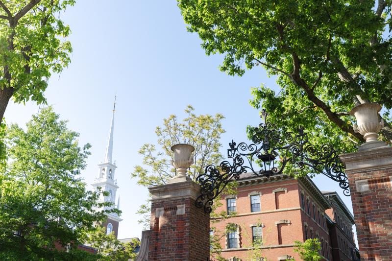 Gate and Memorial Church Spire in the background with green trees