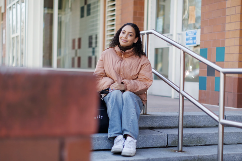 As a high school student, Maya Counter ’24 led the effort to rename the residential Cambridge neighborhood where she grew up from Agassiz to Baldwin. She is pictured outside her elementary school, named after educator and civic leader Maria L. Baldwin, the first Black school principal in the Northeast.